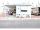 Charming mobile home featuring a covered parking area and a cozy front porch at 7807 E Main St # F-30, Mesa, AZ 85207