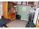 A blue massage table in a room with cabinets, decor, and access to a small set of stairs at 7807 E Main St # F-30, Mesa, AZ 85207
