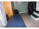 A blue massage table in a tiled room with cabinets, decor, and access to a small set of stairs at 7807 E Main St # F-30, Mesa, AZ 85207