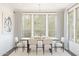 Elegant dining room with a wooden table, upholstered chairs, natural light, and contemporary decor for Gathering gatherings at 7970 W Griswold Rd, Peoria, AZ 85345