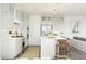 A well-lit kitchen featuring stainless steel appliances, a center island with seating, and contemporary light fixtures at 7970 W Griswold Rd, Peoria, AZ 85345