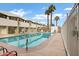 Community pool surrounded by palm trees offers a refreshing outdoor amenity for residents to enjoy at 815 N Hayden Rd # B110, Scottsdale, AZ 85257