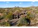 Aerial view of luxury estate featuring private drive and manicured landscaping at 9290 E Thompson Peak Pkwy # 470, Scottsdale, AZ 85255