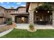 Inviting backyard patio with stone columns, lush greenery, and an outdoor dining area at 9290 E Thompson Peak Pkwy # 470, Scottsdale, AZ 85255
