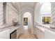 Elegant bar area with custom cabinets, granite countertops, wine refrigerator, and access to the pool at 9290 E Thompson Peak Pkwy # 470, Scottsdale, AZ 85255