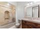 Bathroom with tiled shower, framed mirror, granite countertop, and wood cabinet at 9290 E Thompson Peak Pkwy # 470, Scottsdale, AZ 85255