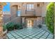 Beautiful courtyard featuring an outdoor staircase, stone archway, and decorative stone and turf flooring at 9290 E Thompson Peak Pkwy # 470, Scottsdale, AZ 85255