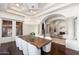 Formal dining room with a chandelier, large table, and access to the living room at 9290 E Thompson Peak Pkwy # 470, Scottsdale, AZ 85255