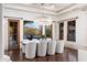 Bright dining room with a modern chandelier, a view of the pool, and seating for eight at 9290 E Thompson Peak Pkwy # 470, Scottsdale, AZ 85255