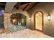Elegant entrance with stone columns, archway, and ornate wood door at 9290 E Thompson Peak Pkwy # 470, Scottsdale, AZ 85255