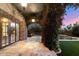 Covered patio with stone columns, vine-covered arch, and outdoor lights at 9290 E Thompson Peak Pkwy # 470, Scottsdale, AZ 85255