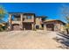 Stunning multi-level home featuring stone accents, multiple garages, and a spacious brick driveway at 9290 E Thompson Peak Pkwy # 470, Scottsdale, AZ 85255