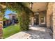 Covered patio adorned with lush vines, stone pillars, and elegant lighting, creating a charming outdoor space at 9290 E Thompson Peak Pkwy # 470, Scottsdale, AZ 85255