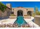 Striking exterior view featuring a gorgeous pool and a stone archway, creating an inviting and luxurious outdoor space at 9290 E Thompson Peak Pkwy # 470, Scottsdale, AZ 85255