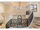 Grand foyer with a decorative wrought iron staircase and view to the outdoor landscape at 9290 E Thompson Peak Pkwy # 470, Scottsdale, AZ 85255