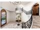 Grand foyer with a winding staircase, wrought iron railings, and marble tile flooring at 9290 E Thompson Peak Pkwy # 470, Scottsdale, AZ 85255