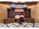 Elegant home office featuring custom wood built-ins, desk, and travertine floors at 9290 E Thompson Peak Pkwy # 470, Scottsdale, AZ 85255