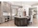 Gourmet kitchen with large center island, stone accents, custom cabinetry, and professional-grade appliances at 9290 E Thompson Peak Pkwy # 470, Scottsdale, AZ 85255