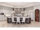 Spacious kitchen with stone accent wall, large island with seating, and high-end appliances at 9290 E Thompson Peak Pkwy # 470, Scottsdale, AZ 85255