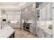 Chef's kitchen featuring custom cabinets, stone backsplash, stainless steel appliances, and expansive counter space at 9290 E Thompson Peak Pkwy # 470, Scottsdale, AZ 85255