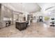Open-concept kitchen featuring stone accents, custom cabinetry and a large island with seating at 9290 E Thompson Peak Pkwy # 470, Scottsdale, AZ 85255