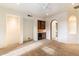 Open living room with carpet, wet bar and arched doorway to outside at 9290 E Thompson Peak Pkwy # 470, Scottsdale, AZ 85255