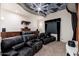 Home theatre boasting plush leather seating, custom ceiling artwork, and built-in shelving at 9290 E Thompson Peak Pkwy # 470, Scottsdale, AZ 85255