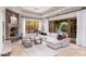 Inviting living room with a stone fireplace, white sofa, and views of the outdoor landscape and pool at 9290 E Thompson Peak Pkwy # 470, Scottsdale, AZ 85255