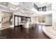 Stunning living room with hardwood floors, a staircase, and a bar area with elegant seating at 9290 E Thompson Peak Pkwy # 470, Scottsdale, AZ 85255