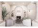 Cozy living room with fireplace, built-in bookshelves, comfortable seating, and stylish decor at 9290 E Thompson Peak Pkwy # 470, Scottsdale, AZ 85255