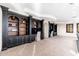 Bright, open loft area featuring custom dark wood built-ins and neutral carpeting at 9290 E Thompson Peak Pkwy # 470, Scottsdale, AZ 85255