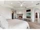 Elegant main bedroom featuring a stone fireplace, TV, and ample natural light at 9290 E Thompson Peak Pkwy # 470, Scottsdale, AZ 85255