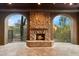 Outdoor fireplace featuring stone surround, gas logs and archways at 9290 E Thompson Peak Pkwy # 470, Scottsdale, AZ 85255
