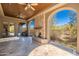 Charming outdoor patio with stone fireplace and ceiling fans, ideal for cozy evenings and outdoor entertainment at 9290 E Thompson Peak Pkwy # 470, Scottsdale, AZ 85255