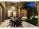 Inviting outdoor patio with stone columns, lush greenery, and dining area at 9290 E Thompson Peak Pkwy # 470, Scottsdale, AZ 85255