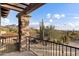 A relaxing outdoor space featuring a stone column, metal railing, desert landscaping and mountain views at 9290 E Thompson Peak Pkwy # 470, Scottsdale, AZ 85255