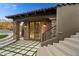 Covered patio with travertine tile, stone pillars, and staircase to upper level at 9290 E Thompson Peak Pkwy # 470, Scottsdale, AZ 85255