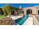 Gorgeous stone home featuring outdoor patio with a sparkling pool and lush climbing plants at 9290 E Thompson Peak Pkwy # 470, Scottsdale, AZ 85255