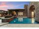 Beautiful backyard pool with stone architecture and lush landscaping at 9290 E Thompson Peak Pkwy # 470, Scottsdale, AZ 85255