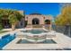 Beautiful water feature with tiled accents complementing the arched stone entrance, enhancing the home's curb appeal at 9290 E Thompson Peak Pkwy # 470, Scottsdale, AZ 85255