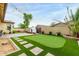 Enjoy a private backyard featuring an artificial turf putting green, brick patio, BBQ, and outdoor cooking area at 9295 W Quail Track Dr, Peoria, AZ 85383
