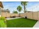 Backyard featuring synthetic lawn, brick patio, BBQ, privacy wall, and string lights at 9295 W Quail Track Dr, Peoria, AZ 85383