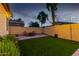 Lush backyard with artificial turf, seating area, and well-maintained landscaping, ideal for outdoor enjoyment at 9295 W Quail Track Dr, Peoria, AZ 85383