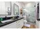 Modern bathroom featuring double sinks, white cabinetry, and a walk-in marble shower at 9295 W Quail Track Dr, Peoria, AZ 85383