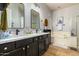 Stylish bathroom featuring a double sink vanity with black fixtures and a soaking tub and shower at 9295 W Quail Track Dr, Peoria, AZ 85383