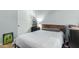 Bedroom with a white quilt and a wooden headboard, plus a sliding door closet at 9295 W Quail Track Dr, Peoria, AZ 85383