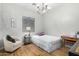 Cozy bedroom featuring a twin bed, a chandelier, and a comfortable chair at 9295 W Quail Track Dr, Peoria, AZ 85383