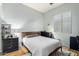 Simple bedroom with a white quilt and a wooden headboard plus two nightstands at 9295 W Quail Track Dr, Peoria, AZ 85383