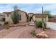 Inviting home featuring desert landscaping, a winding brick path, and a two-car garage at 9295 W Quail Track Dr, Peoria, AZ 85383