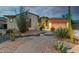 Inviting home featuring desert landscaping, a winding brick path, and a two-car garage at 9295 W Quail Track Dr, Peoria, AZ 85383